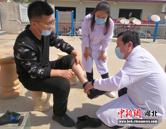 医务人员在脐,为村民提供康复技术服务。 王斌 摄